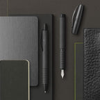 Faber-Castell Essentio Aluminium black ballpoint pen with sleek black body and silver accents, designed for smooth writing.