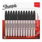 Twelve Sharpie fine tip black ink permanent markers arranged in a row on a white background.